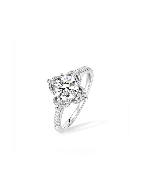 Silver ring with a large central gemstone and smaller stones on a white background