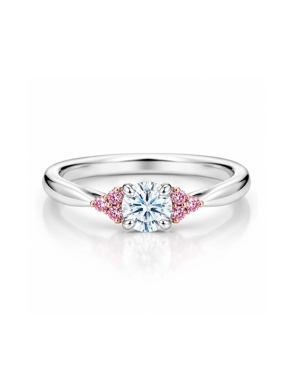 Silver ring with a central diamond and pink gemstones on a white background